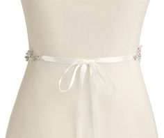 Floral Pearl and Crystal Wedding Dress Belt Our elegant hand-crafted silver bridal belt glistens with matte silver flowers, pave leaves and dainty sprays of sparkling crystals and ivory pearls. This beautiful wedding sash with its on-trend floral vine motif will be the perfect complement to your bridal gown. Size: The decorative appliqué measures 19" long and 1" wide. The ivory satin ribbon is 3/8" wide. Total belt length is 107" (can be trimmed for a perfect fit). Color: Silver//Ivory. Style: 4 Silver Bridesmaid Sashes Bridal Accessories, Elegant Silver Bridal Belt For Bridesmaids, Elegant Silver Bridal Belt For Wedding, White Satin Wedding Sash, White Satin Sashes For Wedding, White Crystal Embellished Bridal Sash, Elegant White Bride Sashes, Elegant White Satin Bridal Belt, White Rhinestone Sashes For Bridesmaids