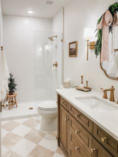 a bathroom with a toilet, sink and bathtub in the middle of it's tiled floor