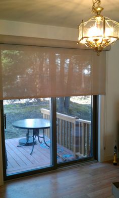 a dining room with sliding glass doors leading to a deck