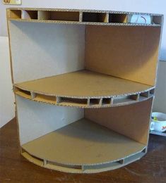 the shelves are made out of cardboard and have holes in them for storing items or other things