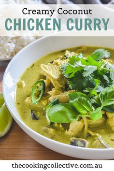 thai green chicken curry in a white bowl with limes and cilantro on the side