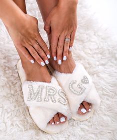 a woman's feet with white nail polish and manicures