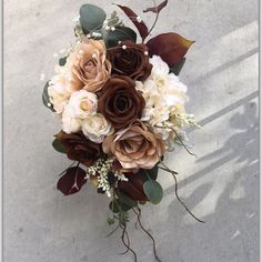 a bridal bouquet with roses and baby's breath in the center is shown