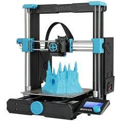 a blue and black 3d printer with castle on the front, sitting next to it