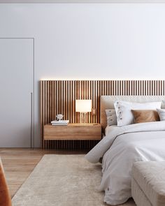 a large bed sitting next to a wooden headboard on top of a white rug