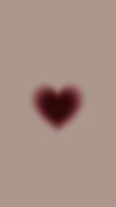 a heart shaped object is shown in the middle of a blurry image with red light