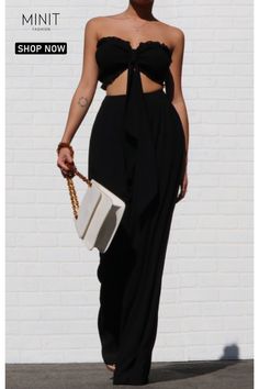 Elevate your summer wardrobe with this stunning black strapless top and high waisted loose pants set. Made from lightweight woven fabric, this set is perfect for hot weather. The smocked tube top features a stylish design with extra-long fabric pieces that can be tied into a bow, creating a fashionable bandeau look. Paired with the high-rise waist and wide-cut pant legs of the matching pants, this set exudes a sense of effortless sophistication and is a go-to choice for any occasion. Elegant Two-piece Summer Pants Set, Elegant Summer Two-piece Pants Set, Summer Two-piece Wide-leg Pants, Versatile Bandeau Tube Top For Day Out, Elegant Two-piece Summer Bottoms Set, Chic Black Strapless Wide Leg Jumpsuit, Chic Black Strapless Wide-leg Jumpsuit, Stretch Pants For Going Out In Summer, Summer Stretch Pants For Going Out