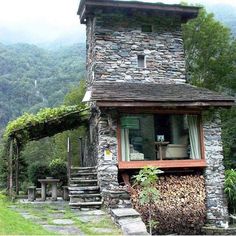 a stone house with steps leading up to it