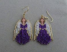 the beaded angel earrings are purple and white