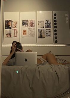 a woman laying in bed using a laptop computer