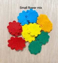 small flower mix in various colors on a wooden surface with the words small flower mix above it