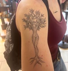 a woman with a tree tattoo on her arm