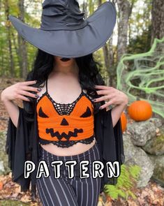 a woman wearing an orange and black top with a halloween pumpkin on it's chest