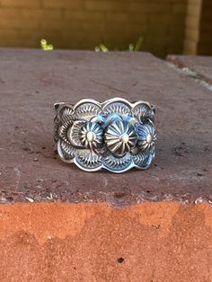 Enhance your western look with our Cassidy Sterling Flower Cigar Band Ring. Handcrafted with intricate floral details, this beautiful ring adds a touch of sophistication to any outfit. Show off your unique style and make a statement with this one-of-a-kind piece! Handmade Cigar Band Sterling Silver Navajo Horse Hair Pottery, Western Rings, Navajo Rings, Bridesmaid Gifts Jewelry, Twisted Band, Authentic Jewelry, Chunky Rings, Jewelry Lookbook, Beautiful Ring