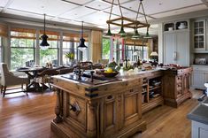 a large kitchen with an island and lots of counter space in front of the windows