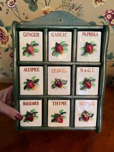 someone is holding up a box that has nine different types of fruit on it, including strawberries and raspberries