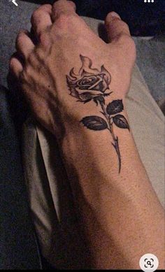 a person's foot with a rose tattoo on it