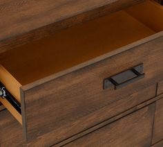 a wooden dresser with two drawers and one drawer open