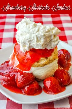 strawberry shortcake sundaes on a white plate with whipped cream and strawberries