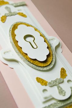 a close up of a card with a gold and white design