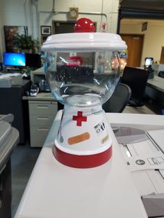 a water dispenser sitting on top of a white counter in an office