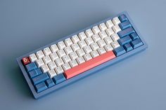 a blue and white computer keyboard sitting on top of a table