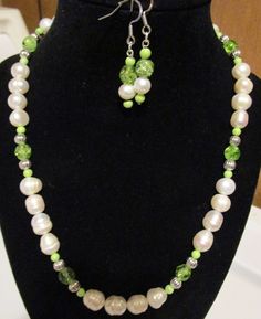 This is a handmade ladies gemstone necklace set. The materials are : cultured (fresh water) pearls, green glass seed beads, green crystals beads and metal. 19" with an ornate, metal toggle clasp Fishhook earrings and bracelet are included. Green Beaded Necklace With Pearl Drop For Gift, Green Pearl Jewelry For May Birthstone, Handmade Green Pearl Jewelry, Green Pearl Round Beads Jewelry, Handmade Green Jewelry Sets With Round Beads, Green Pearl Drop Beaded Necklaces, Green Beaded Pearl Necklace For Jewelry Making, Adjustable Green Pearl Necklace, Green Pearl Necklace With Round Beads And Pearl Drop