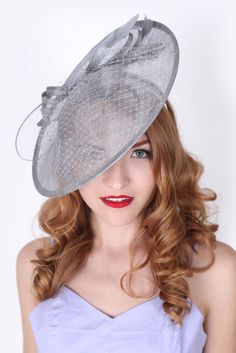 Vintage inspiration, modern attitude. Equipped with netting, feathers, and circular mesh ribbons, this is the fascinator every style setter needs for that special party. Gorgeous in an up-do or with your hair down. A classic wide brimmed fascinator is a cornerstone of any style setter’s hat collection. This fascinator makes a sharply sophisticated statement and a seamless day-to-night transition. - Approx. 13.75 in. - Light and airy - Easy to wear headband - Available in other colors Royal Blue Fascinator, Grey Fascinator, Silver Hat, Feather Bouquet, Historical Hats, Elegant Horse, Blue Fascinator, Black Fascinator, Hat Headband