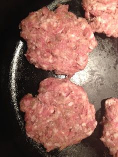 hamburger patties cooking in a frying pan