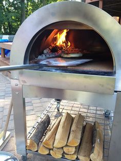 the pizza is being cooked in an outdoor oven