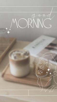 a cup of coffee sitting on top of a wooden table