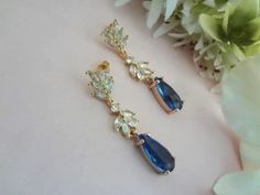 Matching Hair Accessory: https://www.etsy.com/listing/1285364716 Matching Bracelet: https://www.etsy.com/listing/1441332728 These Handmade, crystal earrings are comprised of AAA Cubic Zirconia Marquise Leaf Cluster Long Ear Stud Posts and Sapphire Teardrop in yellow gold plated frame.  The earrings measure .25" in width and 1.58" in length from top of ear post to tip of earring. As the light reflects upon the stone, you'll see light to dark sapphire blue tones. Free USA First Class Standard Ship Elegant Blue Bridal Earrings For Wedding, Bride Something Blue, Blue Wedding Jewelry, Shiny Rings, Retail Jewelry, Something Blue Wedding, Dark Sapphire, Mother Of Bride, Blue Bridal