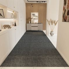 a room with a rug, shelves and vases on the wall next to it