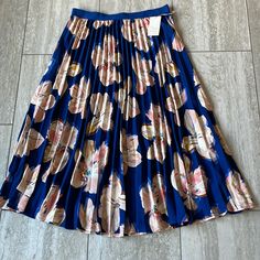 A Pleated Blue Floral Skirt ,A New Day Size Large 100% Polyester Machine Wash Cold With Like Colors In Gentle Cycle Only Nonchlorine Bleach When Needed Tumble Dry, Low Remove Promptly Do Not Iron On Pleats Blue Floral Print Long Skirt, Spring Blue Pleated Skirt Bottoms, Blue Floral Print Full Skirt, Blue Long Pleated Summer Skirt, Blue Pleated Full Skirt, Blue Pleated Skirt For Summer, Casual Blue Pleated Midi Skirt, Casual Blue Full Pleated Skirt, Blue Pleated Midi Skirt Bottoms