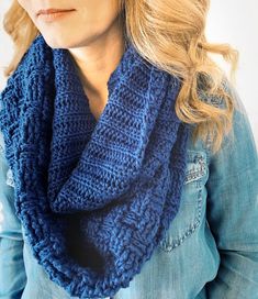 a woman wearing a blue knitted scarf