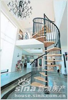 a spiral staircase in a home with chandelier