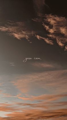 an airplane flying in the sky with some writing on it's side and clouds