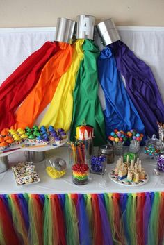 a table topped with lots of rainbow colored food