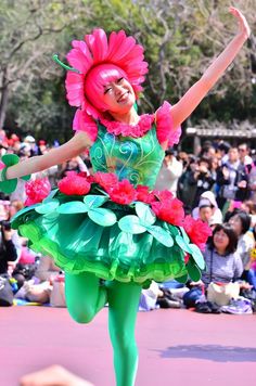 a woman in a green and pink costume