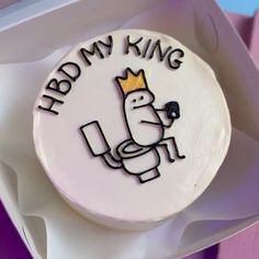 a cake with the words hb my king on it sitting in a white box