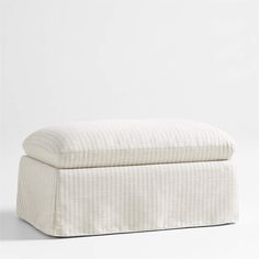 a white ottoman sitting on top of a floor