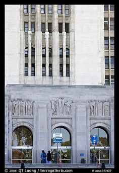 people are standing in front of the entrance to an old building with arches and columns