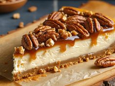 a piece of cheesecake with pecans on top