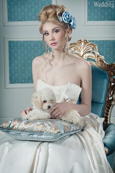 a woman sitting in a chair holding a small white dog on her lap with the caption wedding magazine