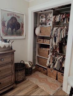 the closet is full of clothes and other things in baskets on the floor next to an old dresser