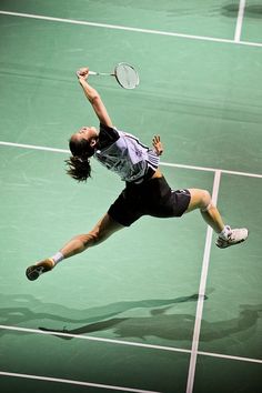 a tennis player in mid air after hitting the ball