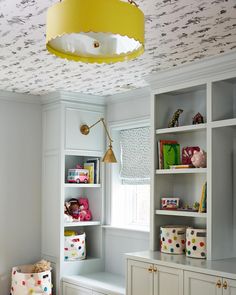 a child's playroom with toys and bookshelves