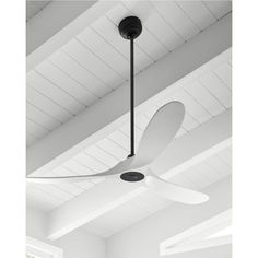 a white ceiling fan hanging from the ceiling