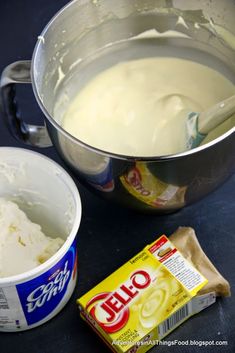 a bowl of ice cream next to a container of yogurt and a bag of jello