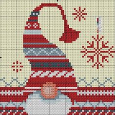 a cross stitch pattern with a red and white hat on top of a pile of snowflakes